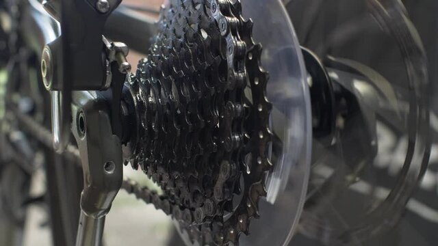Rotating Rear Cycle Cassette With Chain Jumping On Gear Shift. Locked Off, Close Up