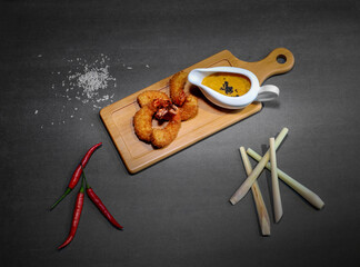 fish and chips, prawns on a Board with sauce and pepper