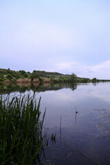 Beautiful river in the highlands in summer. Lake in an ecologically clean park reserve on a background of hills. A pretty landscape in the spring. Stock photo for design