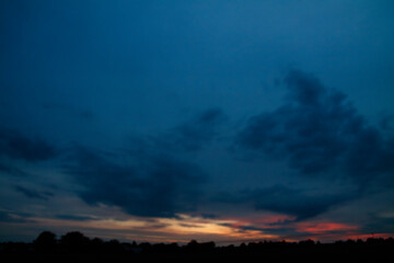 Fototapeta premium Picturesque clouds in the sky. Window view of an airplane on a sunny gloomy day. Stock photo background
