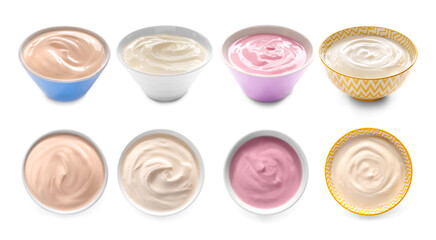 Bowls with different tasty yogurts on white background