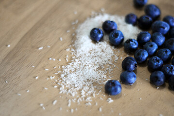 blueberries and coconut on a wooden table