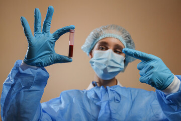 A doctor holds a test tube with a coronavirus positive blood sample. stop coronavirus. MERS....