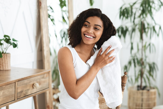 Home Haircare. Smiling African Woman Drying Wet Hair With Towel After Shower