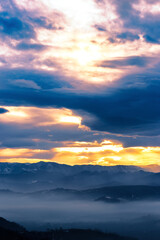 Foggy landscape with light leaking cloudy sky