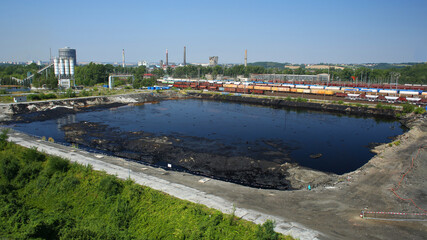 Fototapeta na wymiar Former dump toxic waste, effects nature from contaminated soil and water with chemicals oil fuel, environmental disaster, contamination lagoon pollution
