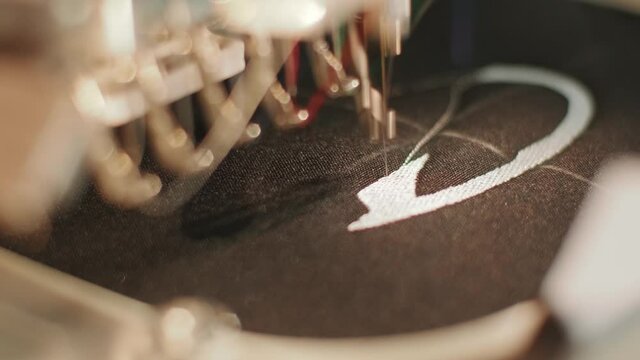 The automatic embroidery machine is working at high speed. Close-up