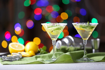 Glasses of tasty cucumber martini on table in bar