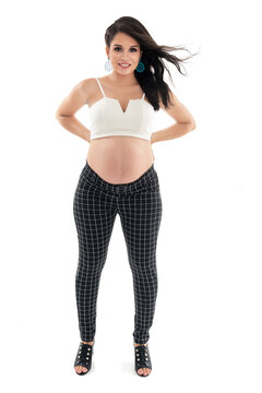 Happy smiling pregnant woman touching her belly isolated on white background. Pregnancy concept studio portrait Mother expecting baby. Baby tea.