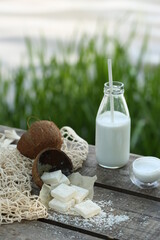 Obraz na płótnie Canvas A bottle of coconut milk with a straw, white marmalade. 