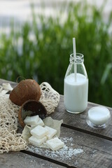 A bottle of coconut milk with a straw, white marmalade.
