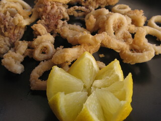 Fried baby squid served with lemon, Catalonia, Spain