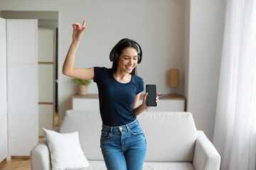 Woman In Headphones Listening To Music Dancing At Home