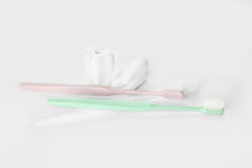 Toothbrushes and teeth on white background