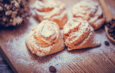 Natural baked coconut cookies or cocoanut macaroons on wooden plate top view, copy space. Homemade cake with coffee beans.