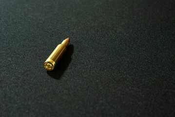 Weapon cartridge isolated on a dark background