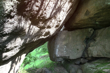 Obraz premium Rocky rock in the mountains with greenery on the background. Stock image for design. cobblestone in nature.