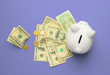 Piggy bank and money on color background
