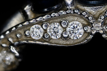 Fototapeta premium Detail of clear diamonds on a white gold ring.