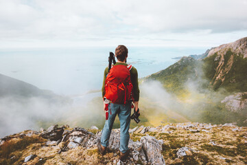 Man traveler hiking with backpack and photo camera in mountains travel influencer blogger hobby...