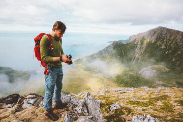 Man photographer with photo camera in mountains travel blogger influencer freelance lifestyle hobby concept adventure summer trip outdoor in Norway