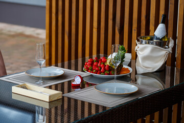 Engagement gold precious jewelry ring for a girl in a red box on a background of fruit