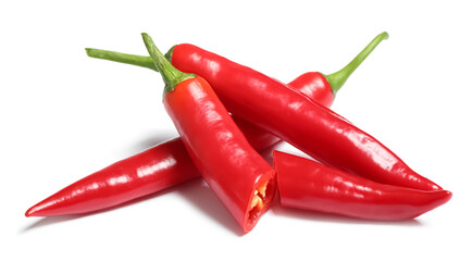 Cut and whole red hot chili peppers on white background