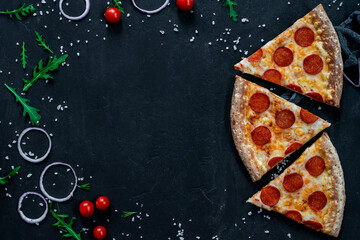 three pieces of Pizza pepperoni with mozzarella on a black background