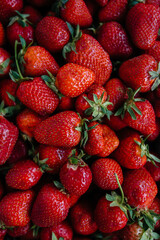Ripe fresh strawberries close-up in a container for sale. Healthy diet