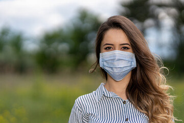 Young woman face in face mask. Woman in medical mask. Flu epidemic and virus protection concept. Close-up	