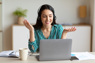 Woman In Headset Working In Customer Support Service Sitting Indoors