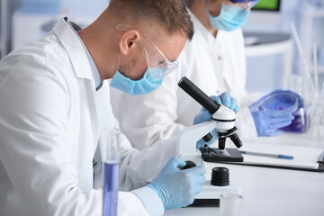 Scientists working with samples in laboratory