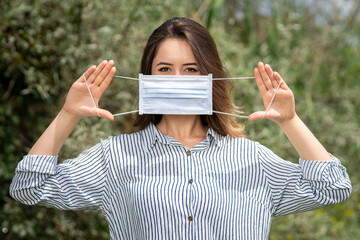 A woman wearing a surgical mask. Mask protects us from corona virus all over the world	