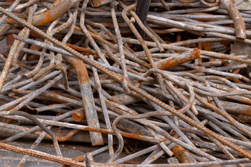 Stack of rusty iron rods or bars. Old metal rusty or steel rod.