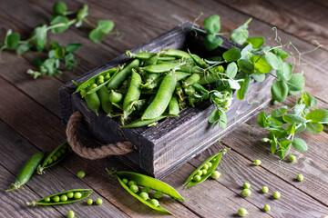Fresh green peas on wooden background
