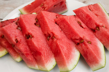 Red watermelon triangular piece on white background
