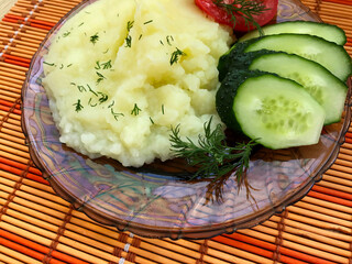 Mashed potatoes on a transparent brown plate.