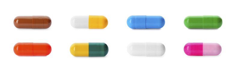 Set with colorful pills on white background, top view. Banner design