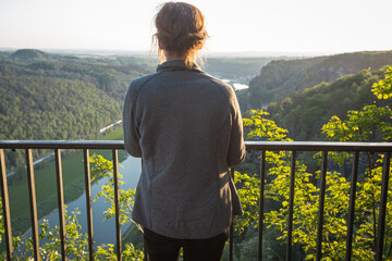Fototapeta premium Rear view of a pensive senior woman outdoor in the nature
