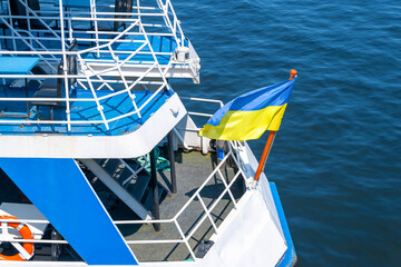 Flag of Ukraine on a ship. Ukrainian flag at the stern of the river ship. Water river transport.