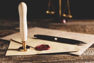 Envelope with notary public wax seal on table