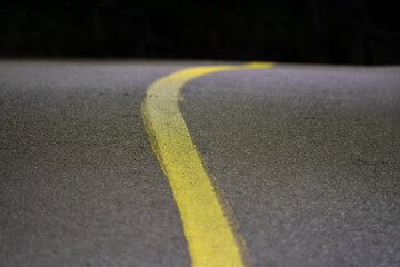 Naklejka na ściany i meble Yellow line on the asphalt in midnight