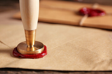 Envelope with notary public wax seal on table, closeup - obrazy, fototapety, plakaty