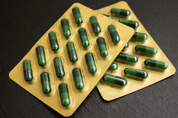 Close up of pills on black background