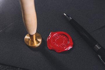 Envelope with notary public wax seal and pen, closeup