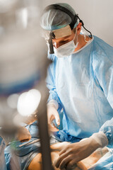 Surgeon insert silicone implant in chest of woman. Tits augmentation plastic operation and correction in medical clinic. Group of professional medics in medical masks and gloves do plastic surgery © Rabizo Anatolii