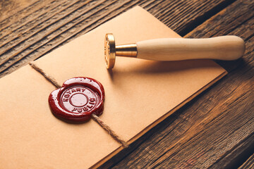 Envelope with notary public wax seal on table, closeup - obrazy, fototapety, plakaty