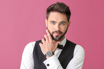 Young man in formal clothes on color background