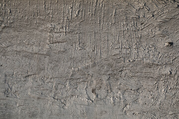Painted wooden surface. The background is a weathered old surface. Scratches and cuts