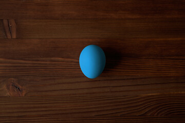Colorful eggs for Easter on a wooden table. View from above.